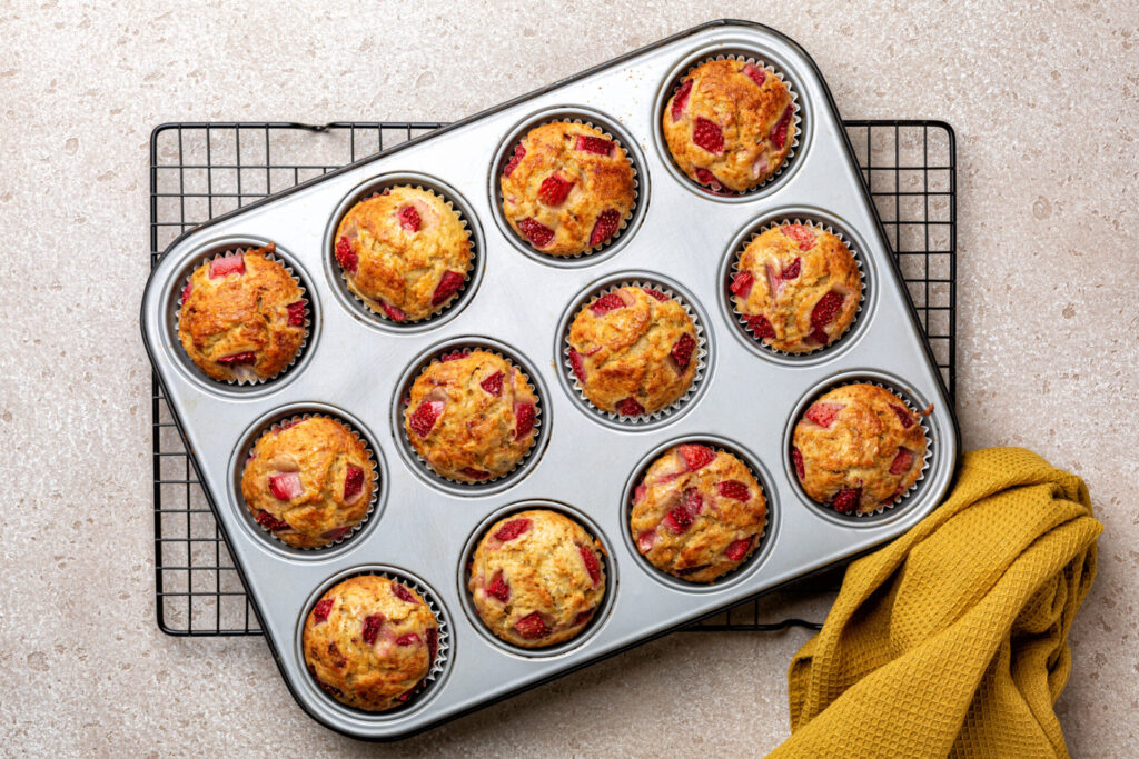 Just baked strawberry sour cream muffins in a metal slot muffins tray