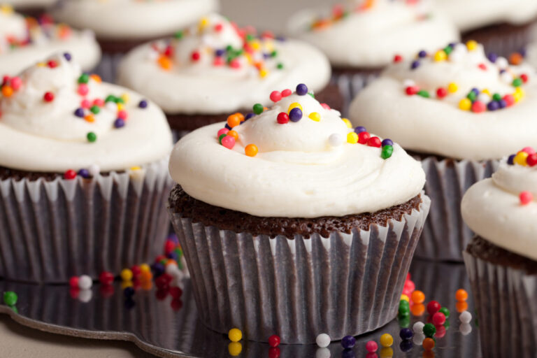 Chocolate cupcakes with cream cheese frosting and sprinkles