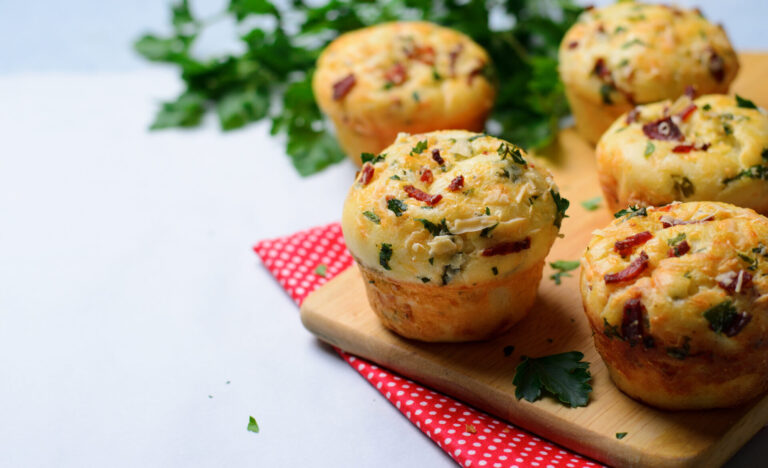 Ham and cheese muffins placed on a cutting board on top of a red napkin