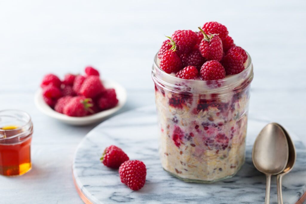 Overnight oats in a mason jar with berries, to illustrate overnight oat recipes
