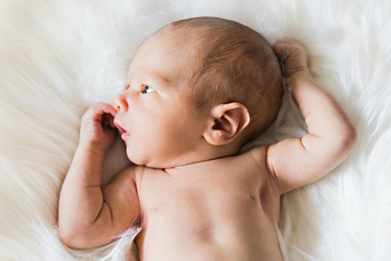 Baby on a white background, to illustrate how to choose a baby name