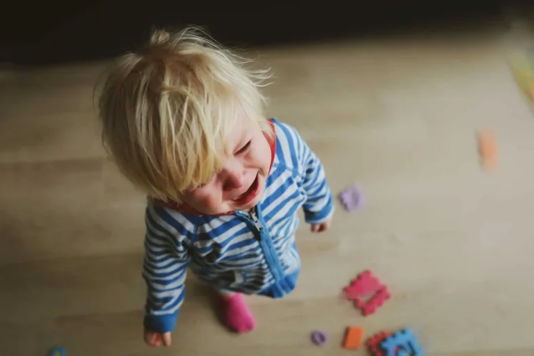 A blonde child crying, to illustrate the age-by-age guide to coping with separation anxiety