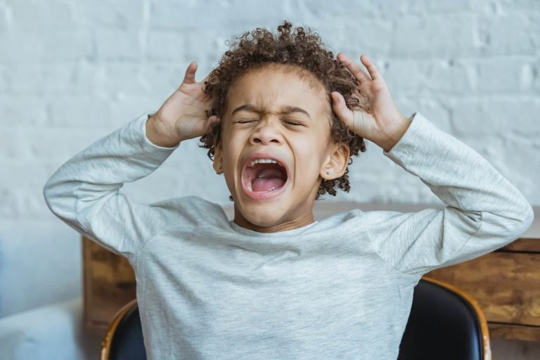 Overstimulated, emotional child represents after-school restraint collapse