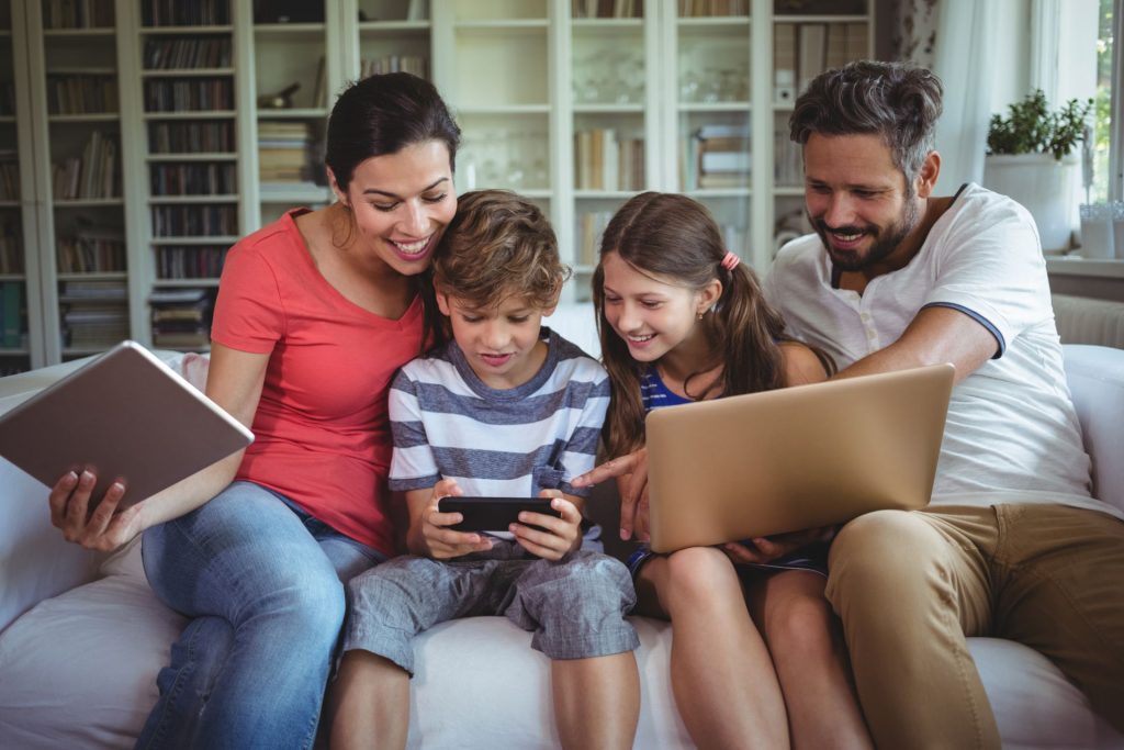 Family enjoying tech freebies on three devices