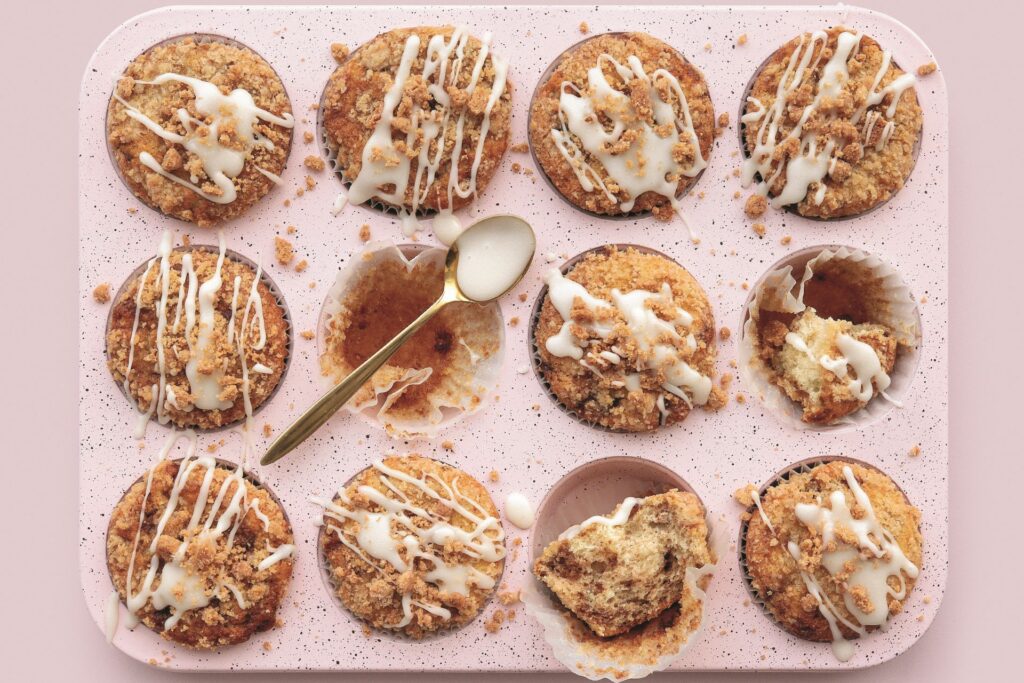 Tray of coffee cake swirl muffins with icing drizzle