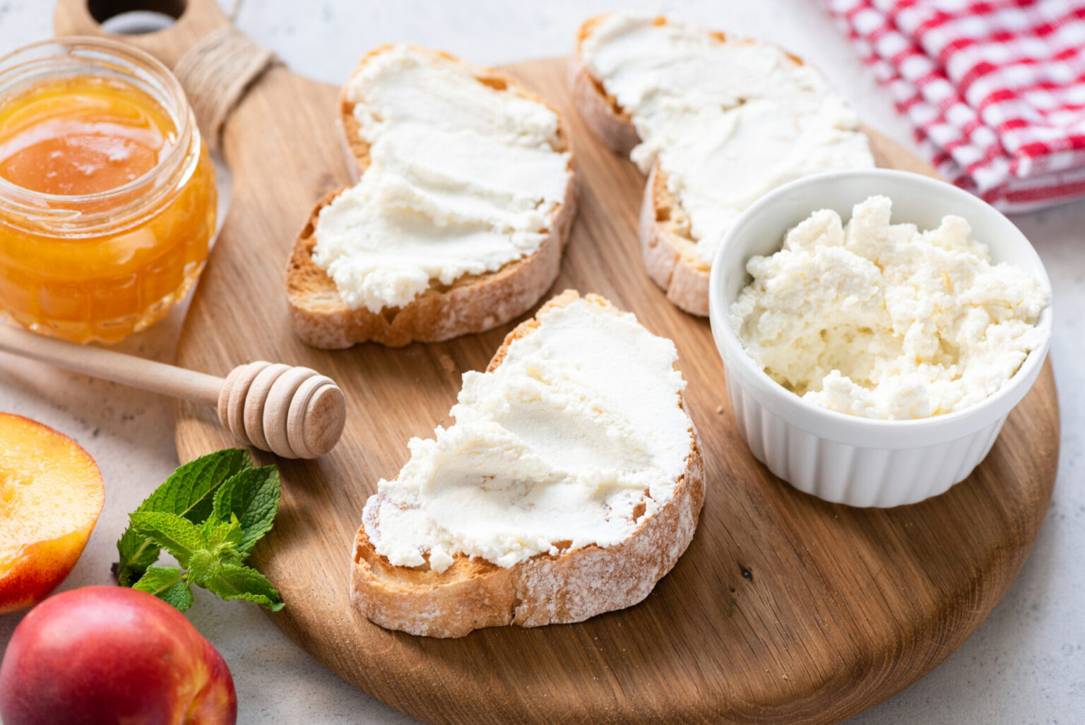 Toast with ricotta spread on a wooden cutting board