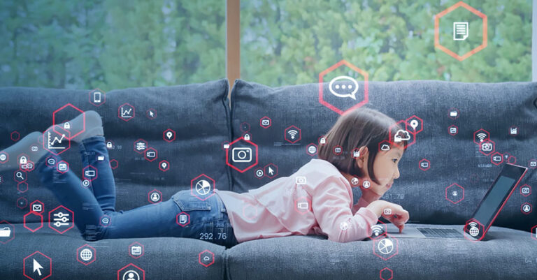 Little girl using a laptop PC.