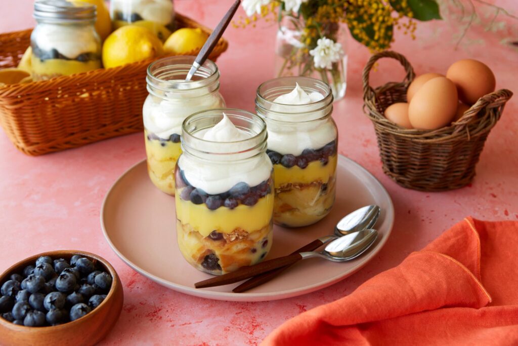 mason jars of lemon blueberry bread pudding sit on a table