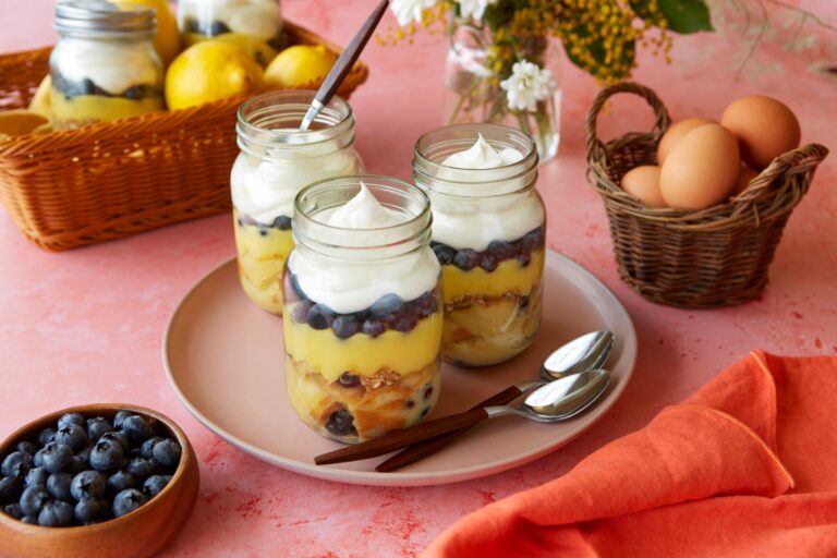 mason jars of lemon blueberry bread pudding sit on a table