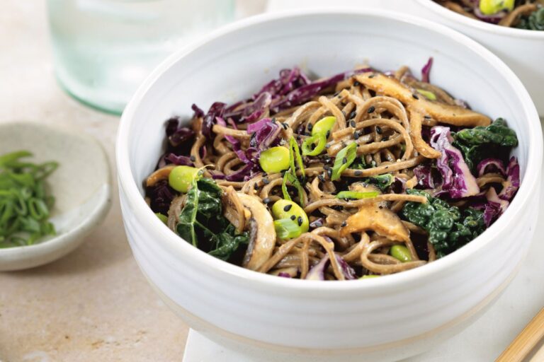 Bowl of soba noodles with veggies and a peanut sauce