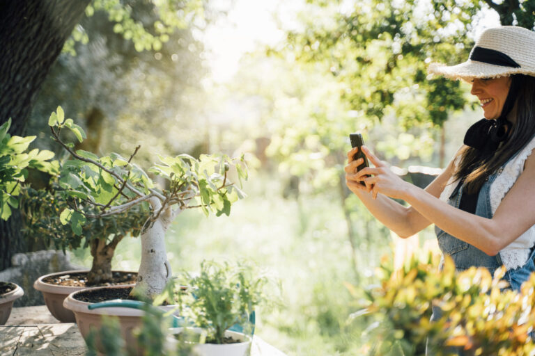 Woman using gardening gadgets and apps to help with growing